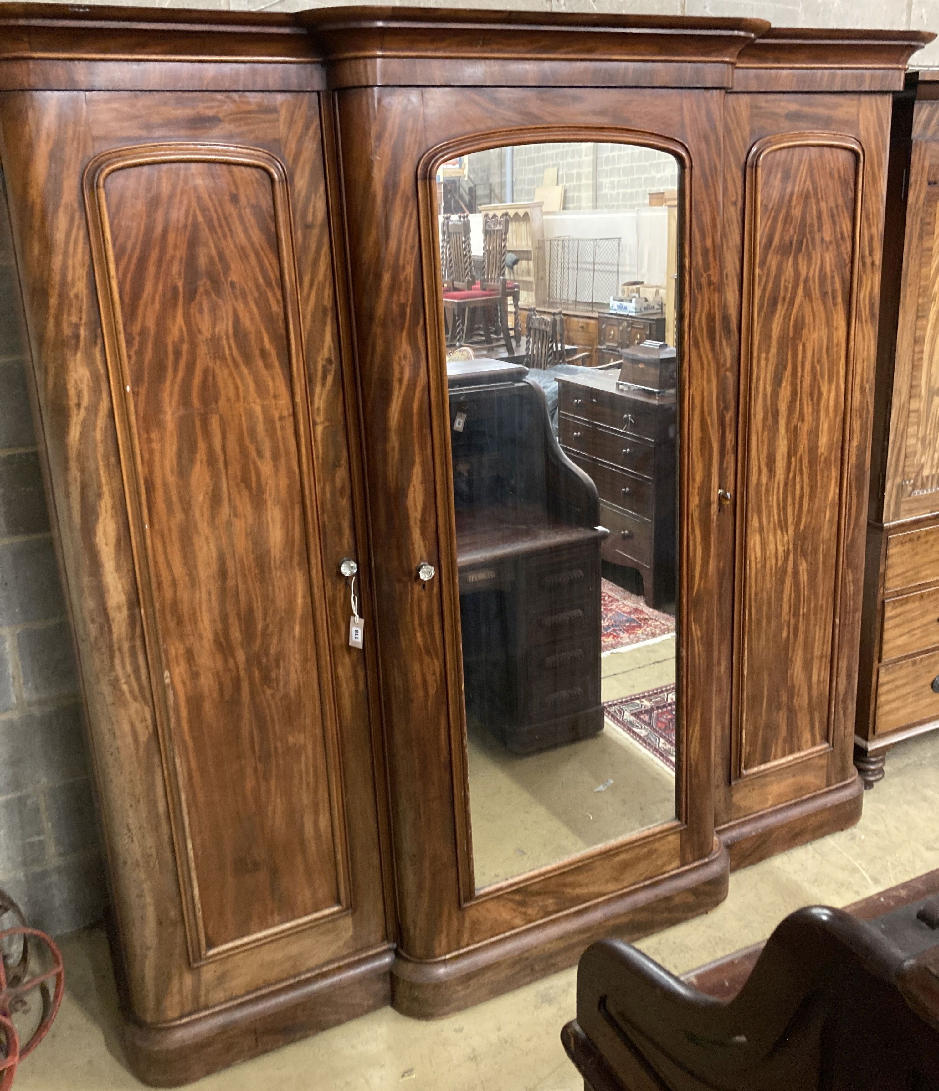 A large Victorian mahogany break front compactum three door wardrobe, length 230cm, depth 60cm, height 226cm